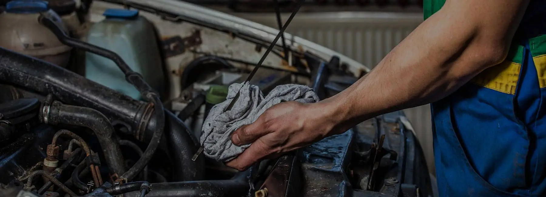 Skilled technician performing oil check at Napleton Chevrolet Buick GMC Beaver Dam service center