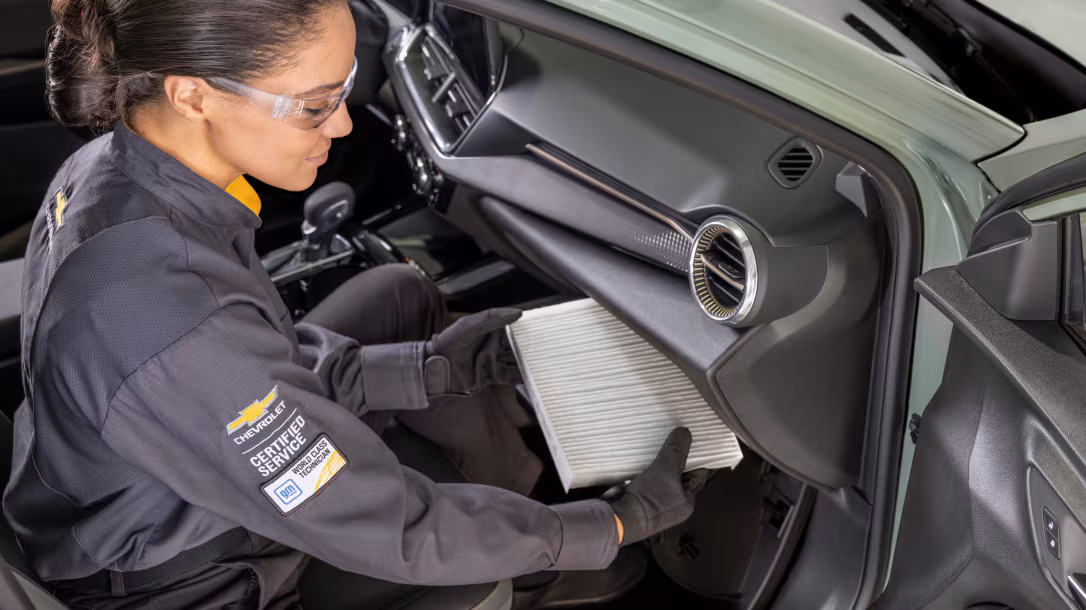 Skilled technician performing oil check at Napleton Chevrolet Buick GMC Beaver Dam service center